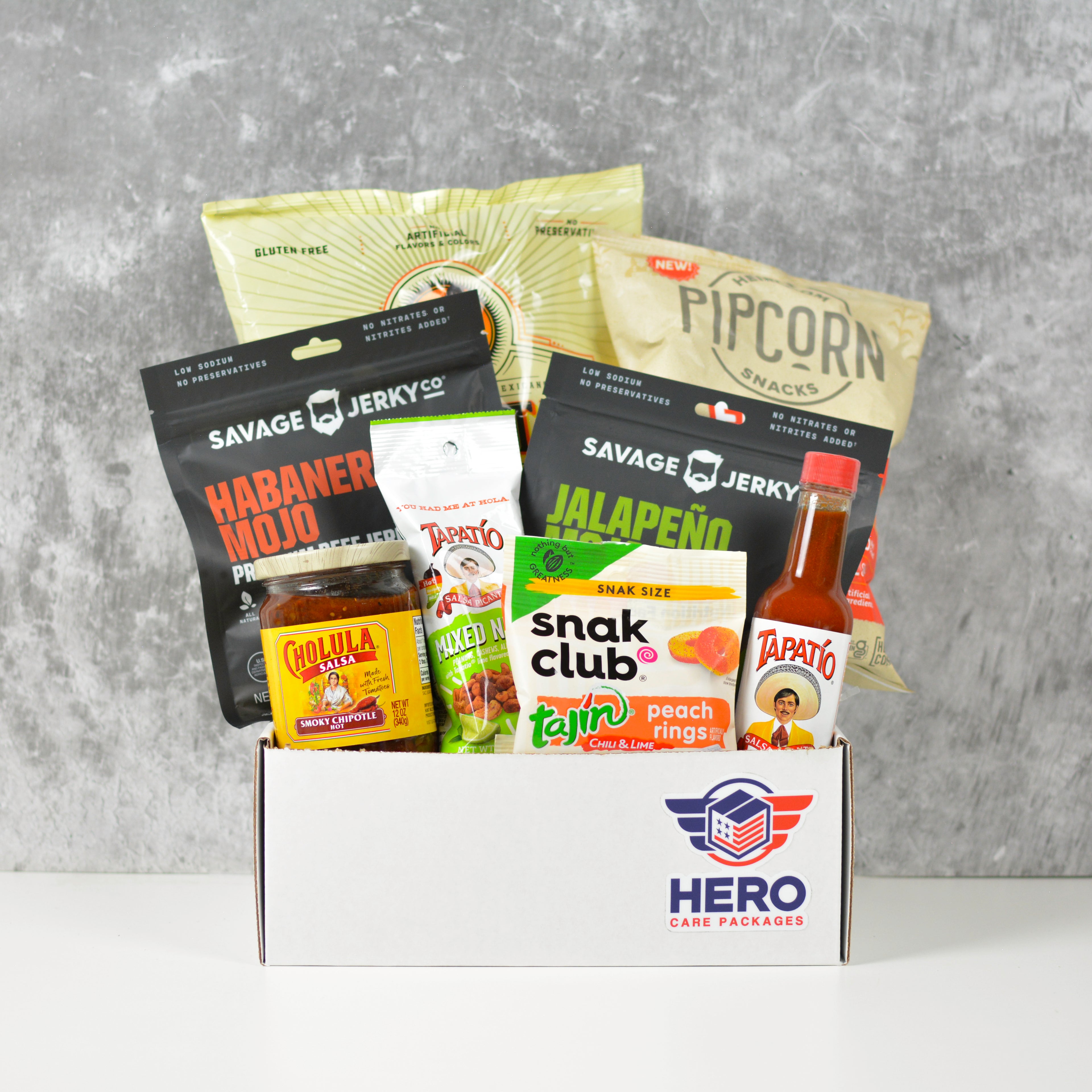 Tactical Heat Military Care Package with spicy snacks, hot jerky, and salsa arranged in a gift box for deployed service members